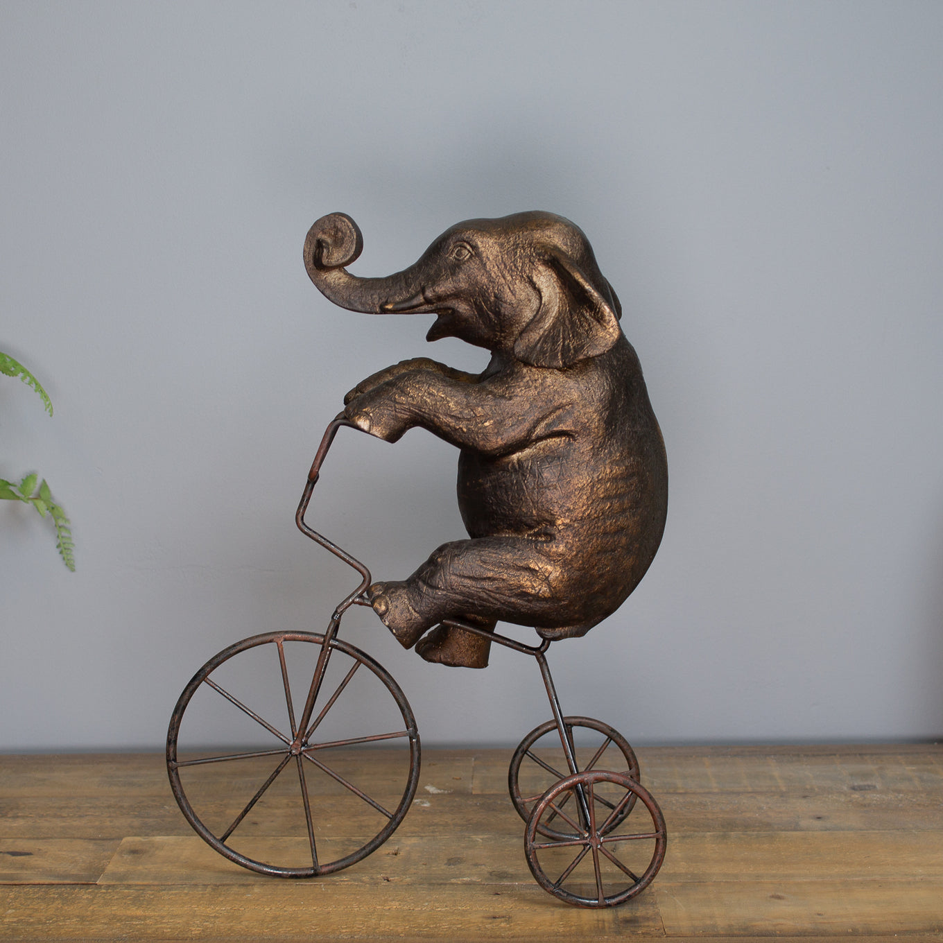 Elephant On Tricycle Sculpture
